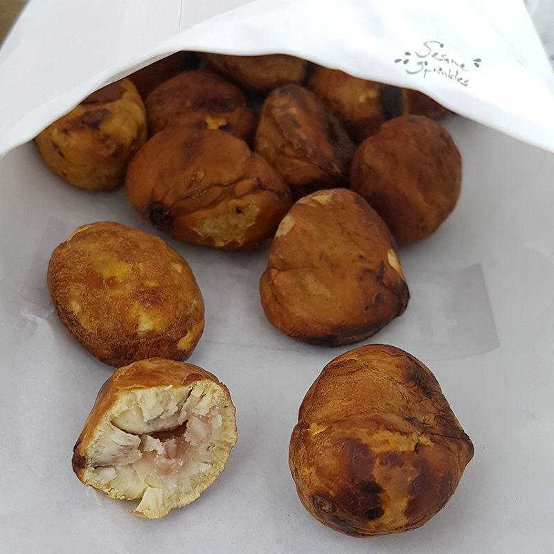 Roasted and peeled chestnuts inside a paper bag.